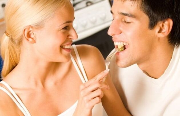 The girl feeds the guy foods for potency